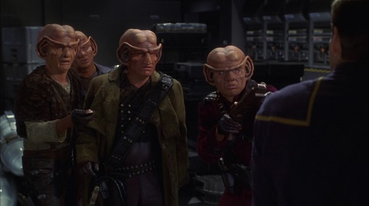 Four Ferengi: Krem, Muk, Grish, and Ulis interrogate Archer for the location of the Vault